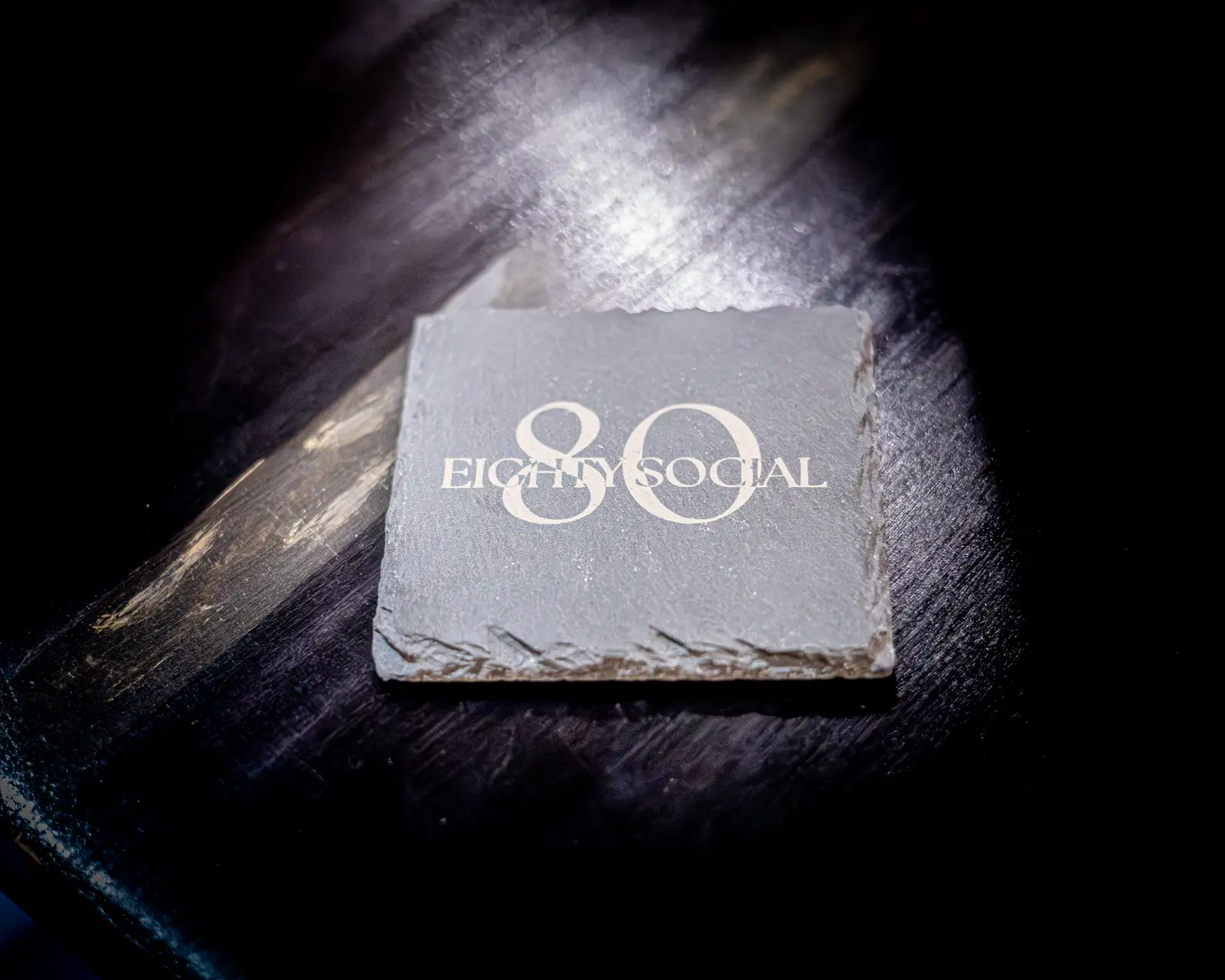 The Eighty Social mark engraved into stone